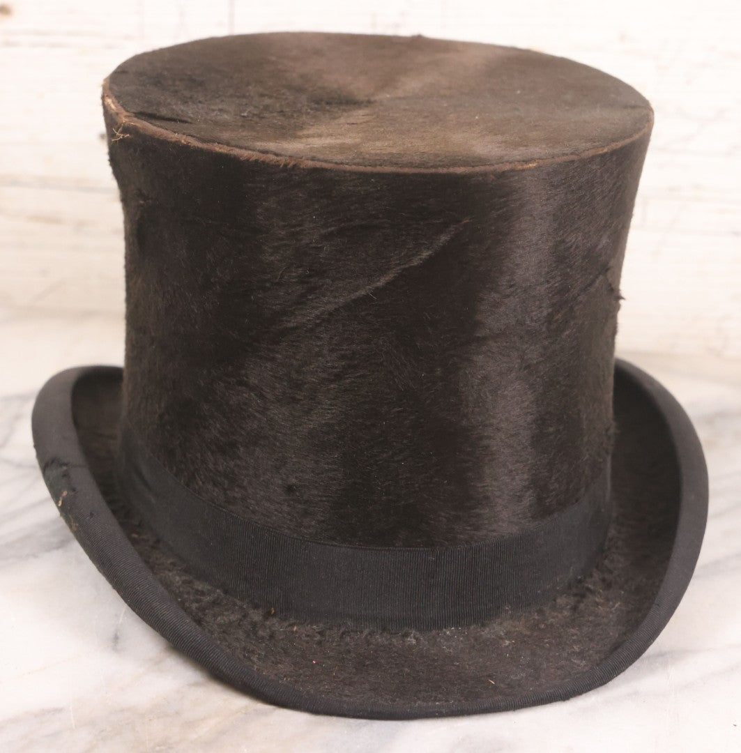 Lot 049 - Antique Beaverskin Stove Pipe Top Hat Manufactured By Alfred Matthews, St. Louis, Missouri, With Dark Mustard Painted Tin Hat Box With Blue-Green Interior
