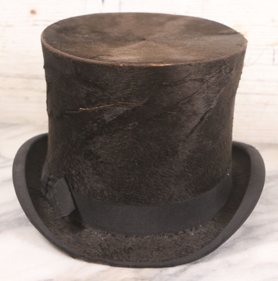 Lot 049 - Antique Beaverskin Stove Pipe Top Hat Manufactured By Alfred Matthews, St. Louis, Missouri, With Dark Mustard Painted Tin Hat Box With Blue-Green Interior
