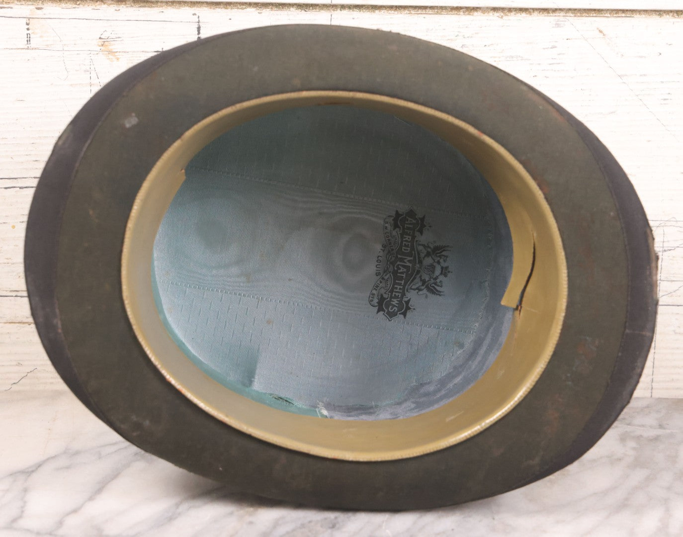 Lot 049 - Antique Beaverskin Stove Pipe Top Hat Manufactured By Alfred Matthews, St. Louis, Missouri, With Dark Mustard Painted Tin Hat Box With Blue-Green Interior