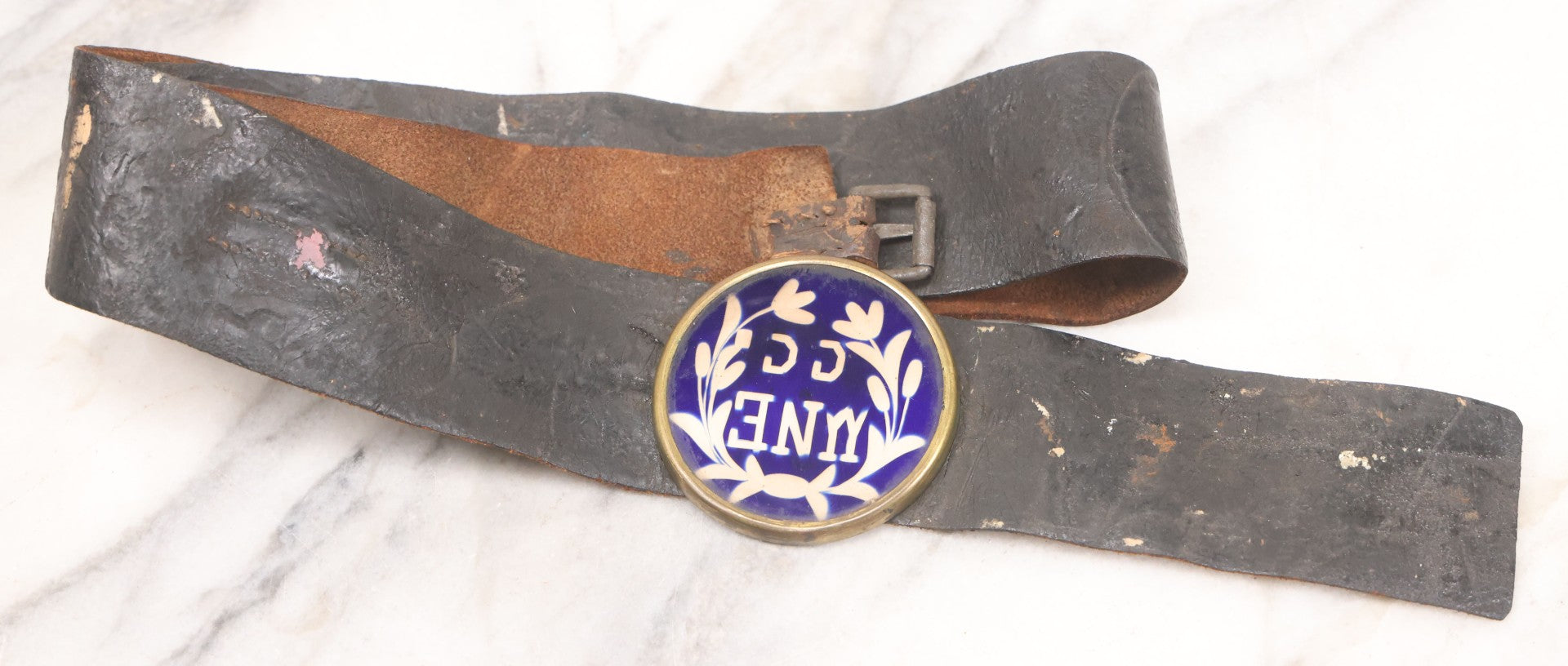 Lot 053 - Antique Leather Belt With Unusual Reverse Painted Glass Enamel Roundel With Laurel Motif, Mirrored Lettering, Unknown Fraternal Order, Circa Late 19th Century