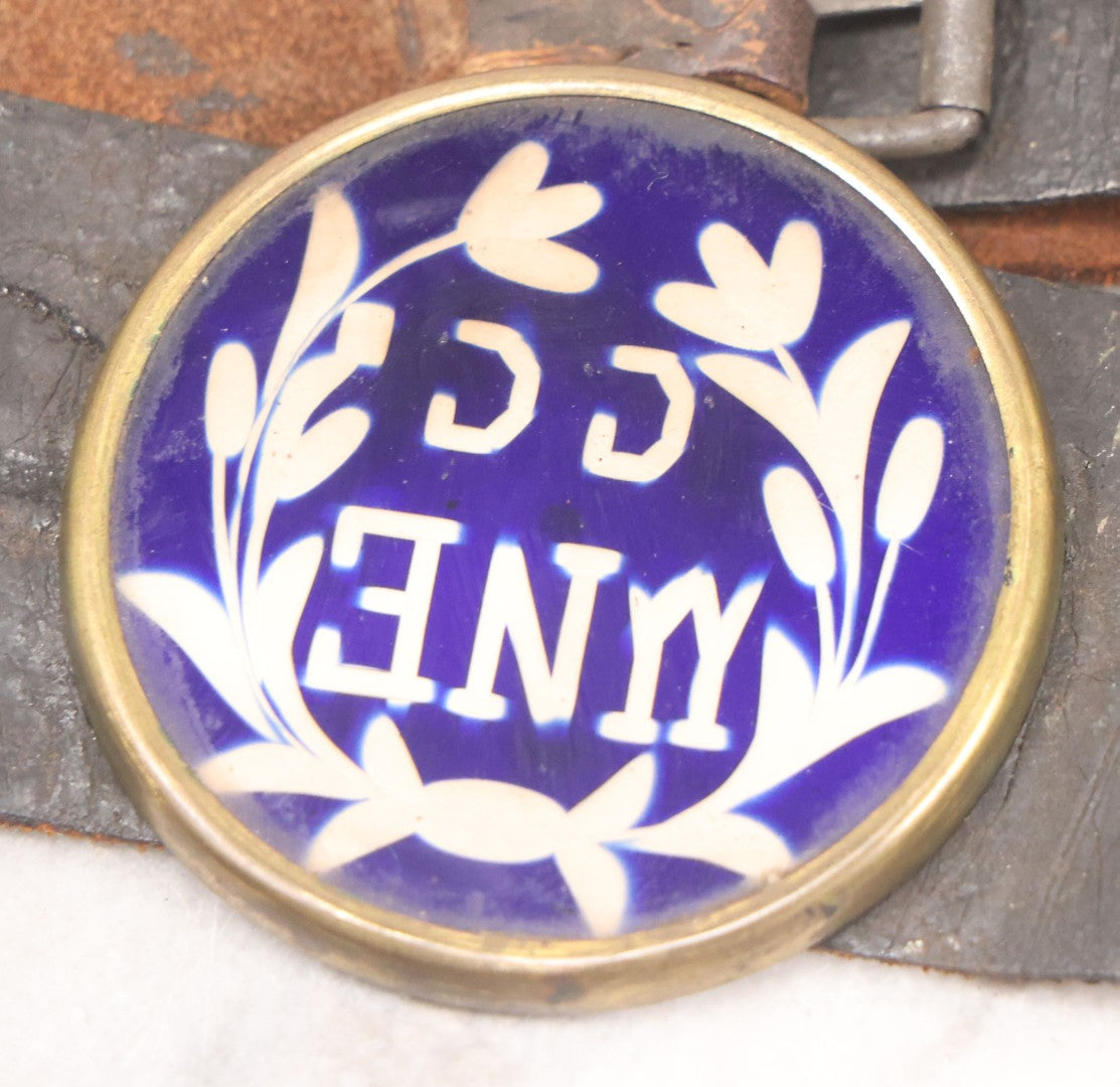 Lot 053 - Antique Leather Belt With Unusual Reverse Painted Glass Enamel Roundel With Laurel Motif, Mirrored Lettering, Unknown Fraternal Order, Circa Late 19th Century