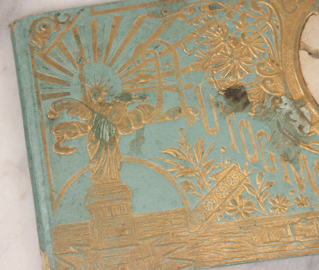 Lot 055 - Antique Victorian Autograph Album With Statue Of Liberty, New York Harbor, Hudson River Themed Embossed Gilt Cover, Cherub Flying On Bee Frontispiece, With Many Autographs From The 1890s Made In Germany