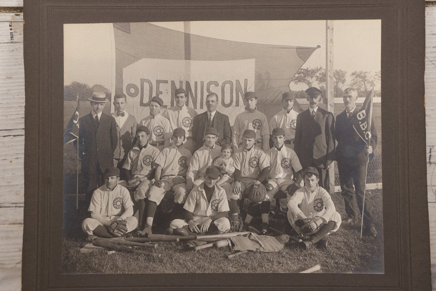 Lot 068 - Antique Boarded Photograph Of The Dennison Manufacturing Co. Baseball Team, Posing With Dennison Banner, Equipment, Circa 1915, Framingham, Massachusetts