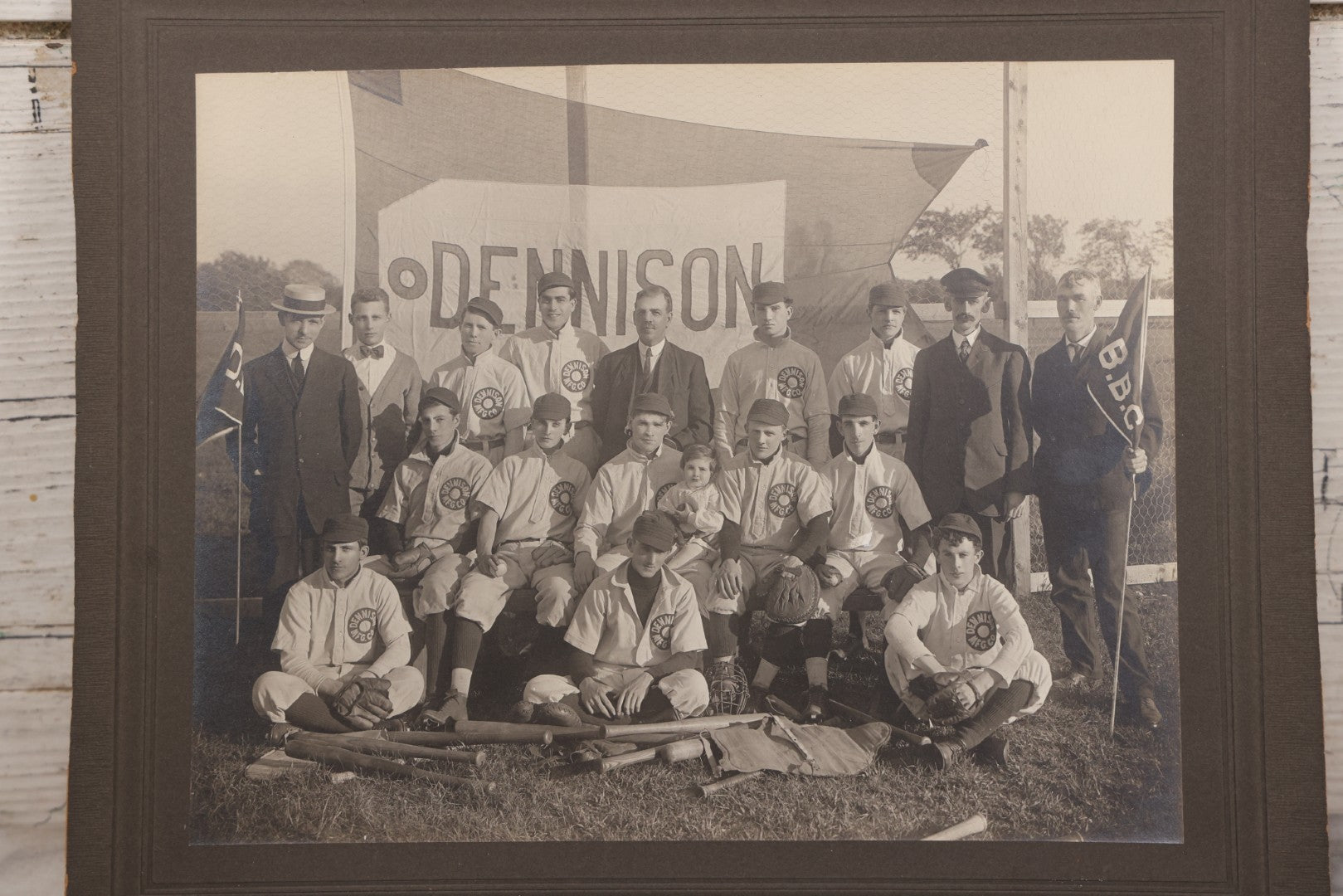 Lot 068 - Antique Boarded Photograph Of The Dennison Manufacturing Co. Baseball Team, Posing With Dennison Banner, Equipment, Circa 1915, Framingham, Massachusetts