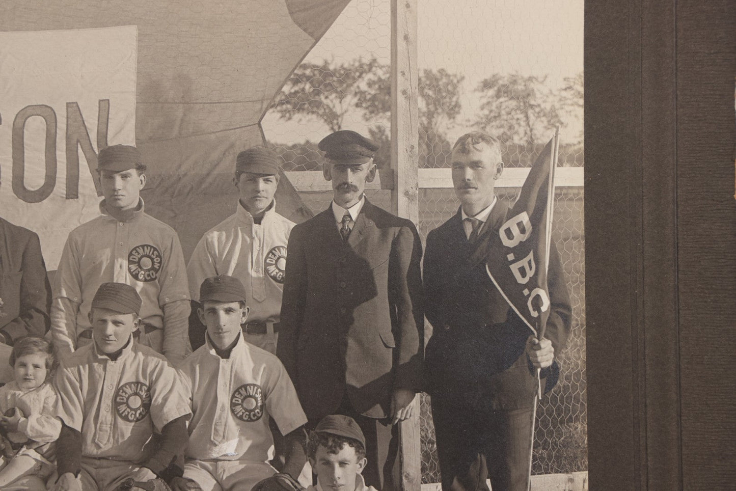 Lot 068 - Antique Boarded Photograph Of The Dennison Manufacturing Co. Baseball Team, Posing With Dennison Banner, Equipment, Circa 1915, Framingham, Massachusetts