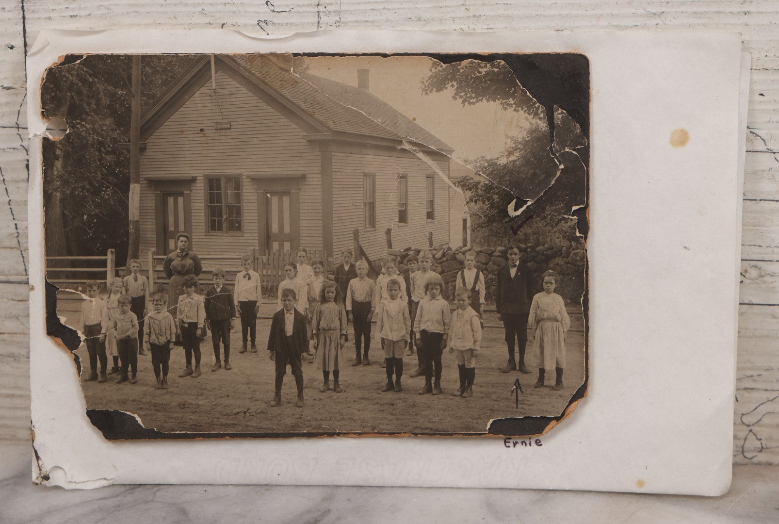 Lot 073 - Antique Boarded Photograph Of School Class Standing Apart And In Unnatural Pose, With Teacher In Front Of "Maple School," One Child Identified As "Ernie" 