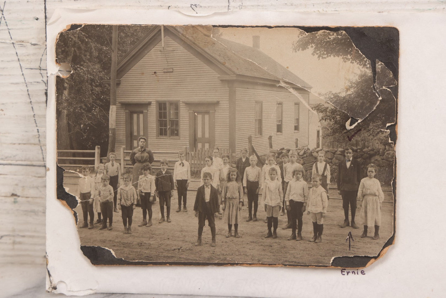 Lot 073 - Antique Boarded Photograph Of School Class Standing Apart And In Unnatural Pose, With Teacher In Front Of "Maple School," One Child Identified As "Ernie" 