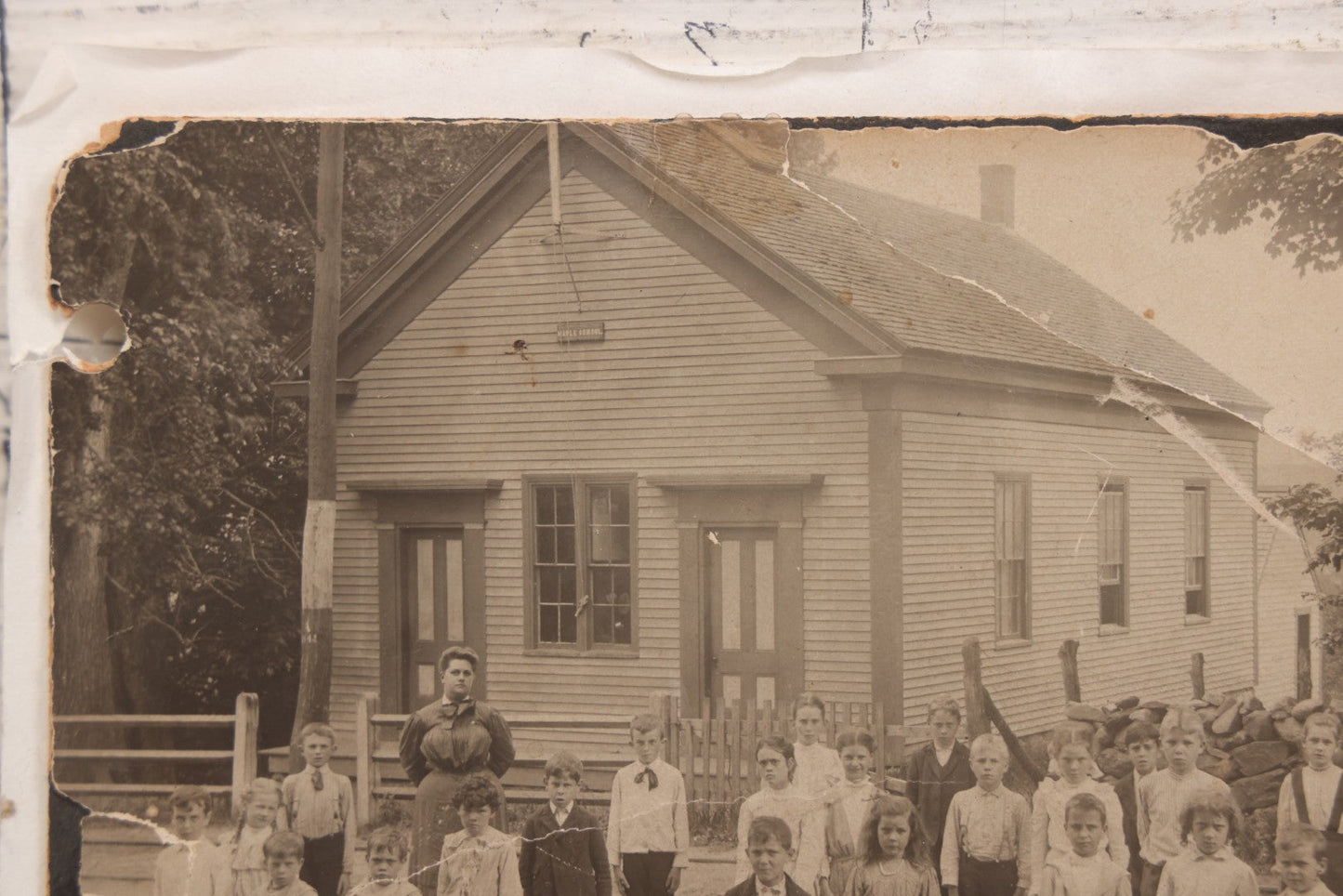 Lot 073 - Antique Boarded Photograph Of School Class Standing Apart And In Unnatural Pose, With Teacher In Front Of "Maple School," One Child Identified As "Ernie" 