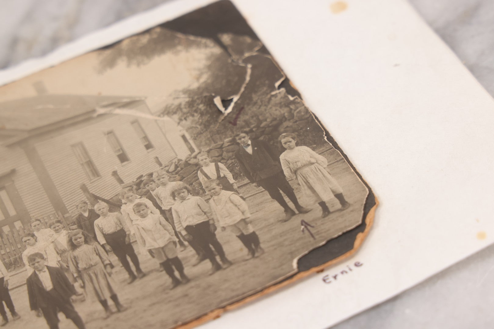 Lot 073 - Antique Boarded Photograph Of School Class Standing Apart And In Unnatural Pose, With Teacher In Front Of "Maple School," One Child Identified As "Ernie" 
