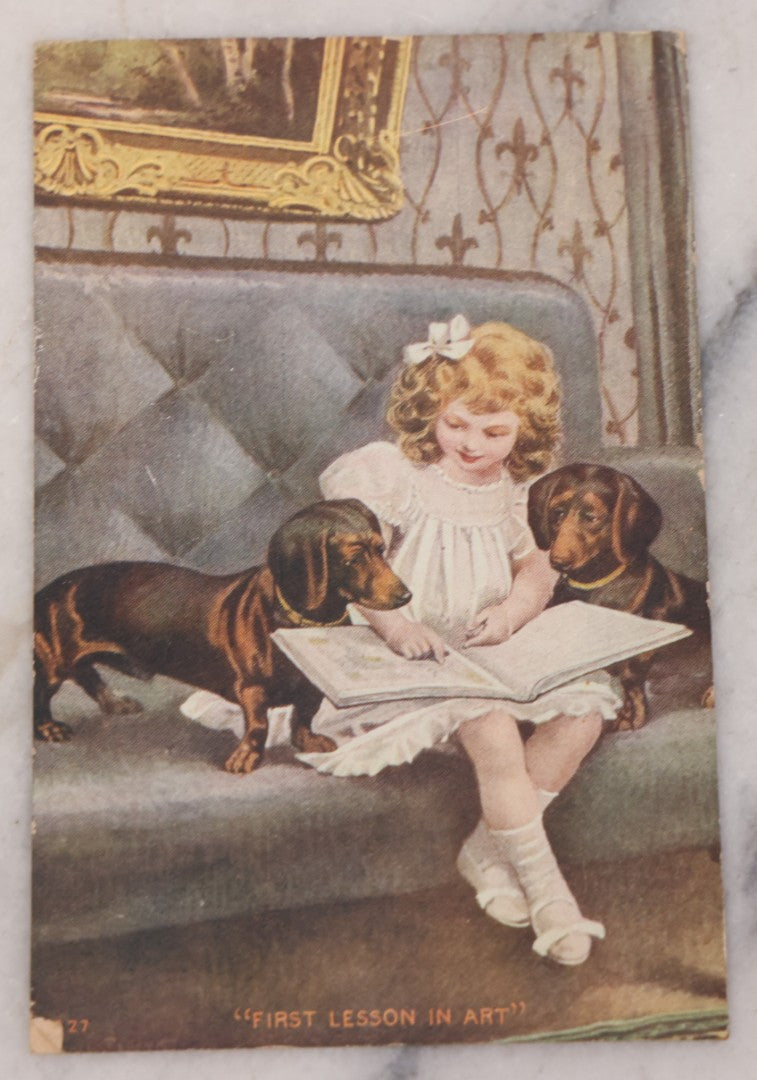 Lot 115 - Grouping Of Two Antique Dog Postcards, Cyanotype Real Photo Postcard R.P.P.C. Of Two Dogs Playing And Wrestling, And "First Lesson In Art" Illustration Of Young Girl Reading To Two Attentive Daschunds 