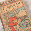 Lot 125 - "Through The Fray; A Tale Of The Luddite Riots" Antique Illustrated Novel By G.A. Henty, Cover And Spine Featuring Depictions Of Weapons And Battle Scenes, Published By A.L. Burt, New York, Circa 1900