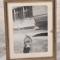Lot 140 - Vintage Snapshot Photograph Of Curious Kitten In Driveway, With Car In Photo, In Vintage Metal Frame, Circa 1950s, 4-1/8" x 5-1/8"