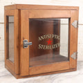 Lot 007 - Antique Wooden Antiseptic Sterilizer Cabinet With Glass Front Door And Reverse Painted Lettering, Red Star Logo, Glass Sides