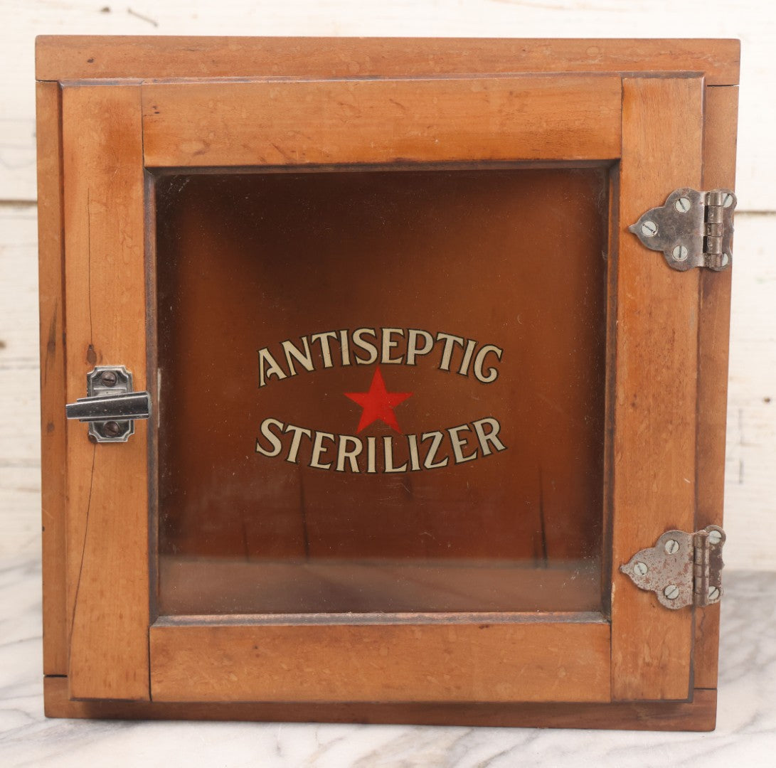 Lot 007 - Antique Wooden Antiseptic Sterilizer Cabinet With Glass Front Door And Reverse Painted Lettering, Red Star Logo, Glass Sides