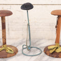 Lot 029 - Trio Of Vintage Hat Stands Including Two With Partial Fabric Coverings And Greenish-Yellow Ribbons, And One Blue Wire Stand With Felt Pillow