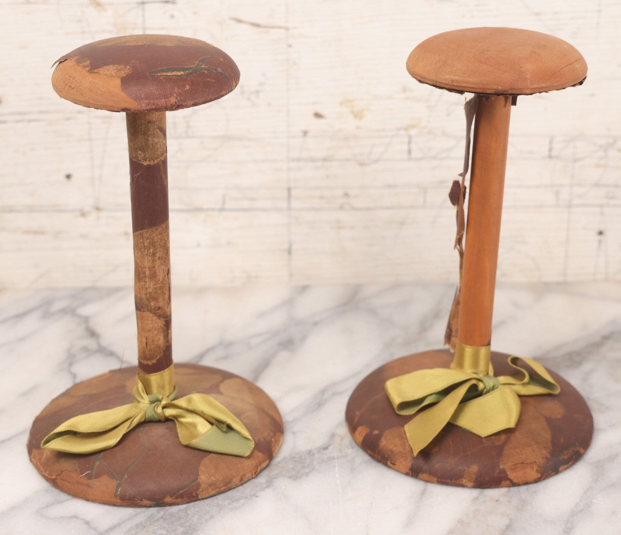Lot 029 - Trio Of Vintage Hat Stands Including Two With Partial Fabric Coverings And Greenish-Yellow Ribbons, And One Blue Wire Stand With Felt Pillow