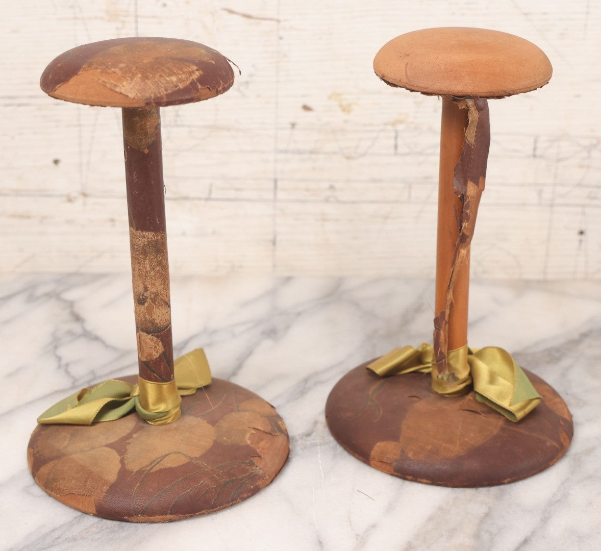 Lot 029 - Trio Of Vintage Hat Stands Including Two With Partial Fabric Coverings And Greenish-Yellow Ribbons, And One Blue Wire Stand With Felt Pillow