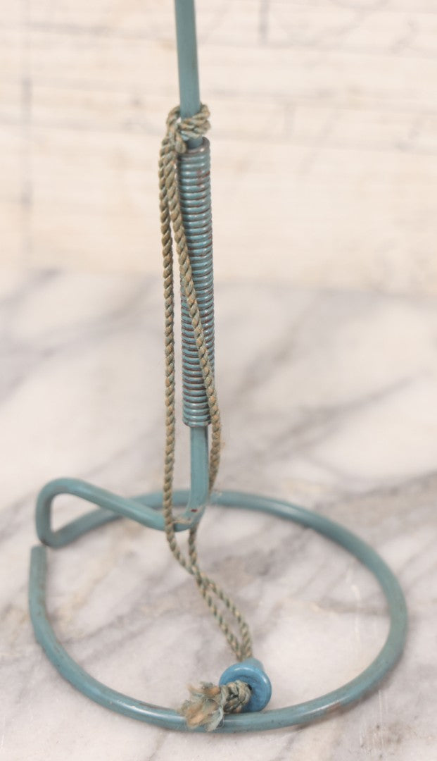 Lot 029 - Trio Of Vintage Hat Stands Including Two With Partial Fabric Coverings And Greenish-Yellow Ribbons, And One Blue Wire Stand With Felt Pillow