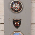 Lot 033 - Vintage Custom Cut Wooden Plaque With Five Metal Car Club Badges Including United States Flag, Austria Österreich, Shriners, A.D.A.C. 1928 Baden Sporttage, And Österreichischen Automobil-Club, 5-1/2" x 20-1/4"
