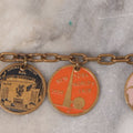 Lot 038 - Vintage Brass Chain Link Charm Bracelet With Six Enameled Souvenir Charms From The New York World's Fair 1939 Including Trylon And Perisphere And Landmark Buildings, 7" Length