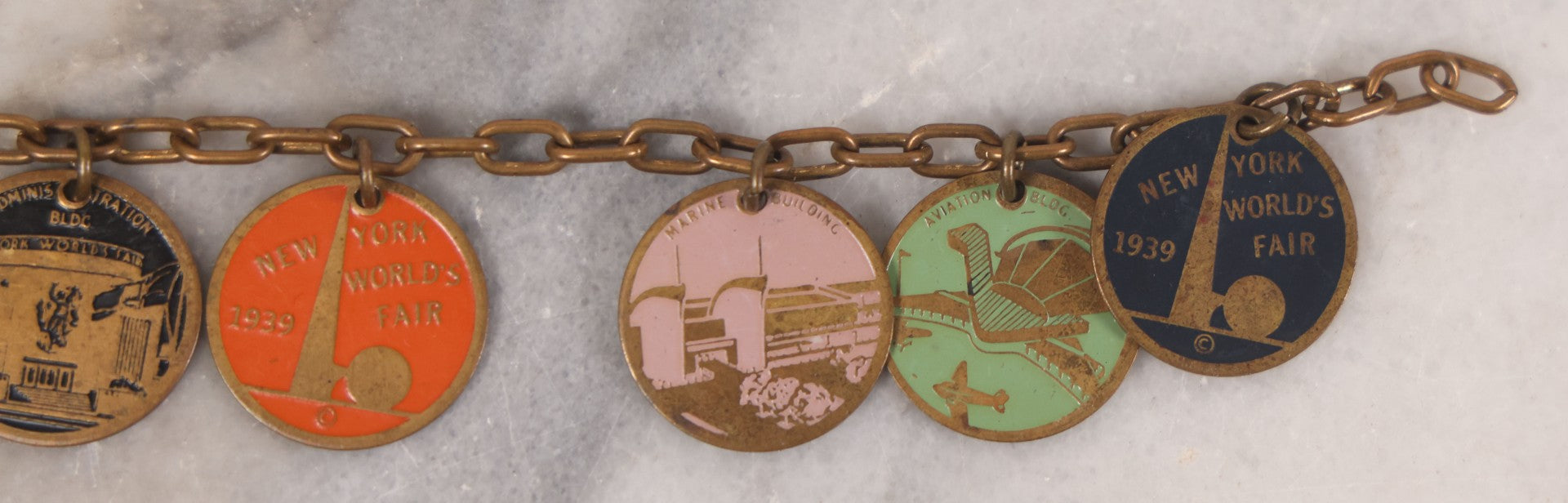 Lot 038 - Vintage Brass Chain Link Charm Bracelet With Six Enameled Souvenir Charms From The New York World's Fair 1939 Including Trylon And Perisphere And Landmark Buildings, 7" Length