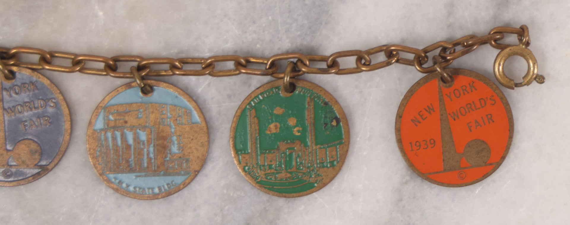 Lot 038 - Vintage Brass Chain Link Charm Bracelet With Six Enameled Souvenir Charms From The New York World's Fair 1939 Including Trylon And Perisphere And Landmark Buildings, 7" Length
