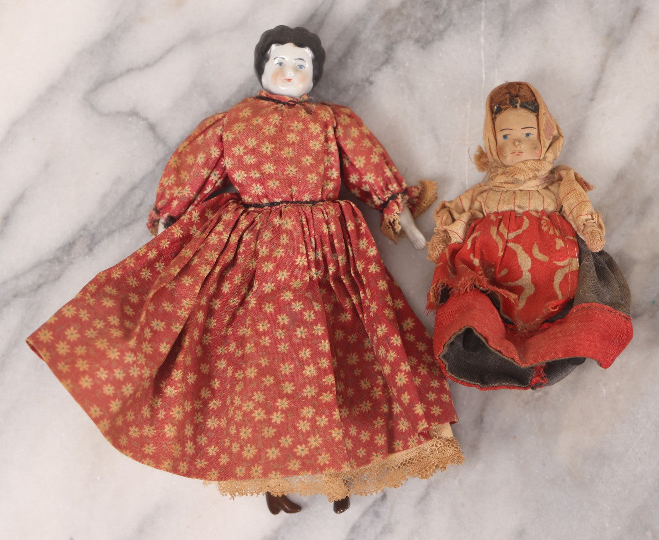 Lot 041 - Pair Of Antique Miniature Dolls Including China Head Doll With Floral Red Dress, Bisque Hands And Feet, And Papier Mache Head Doll With Cloth Body, 4-1/4" H And 7" H