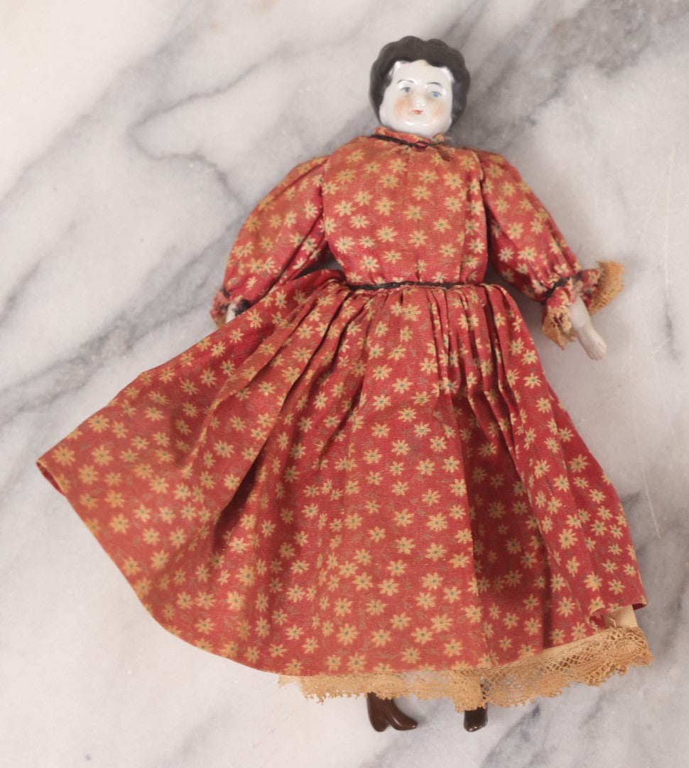 Lot 041 - Pair Of Antique Miniature Dolls Including China Head Doll With Floral Red Dress, Bisque Hands And Feet, And Papier Mache Head Doll With Cloth Body, 4-1/4" H And 7" H