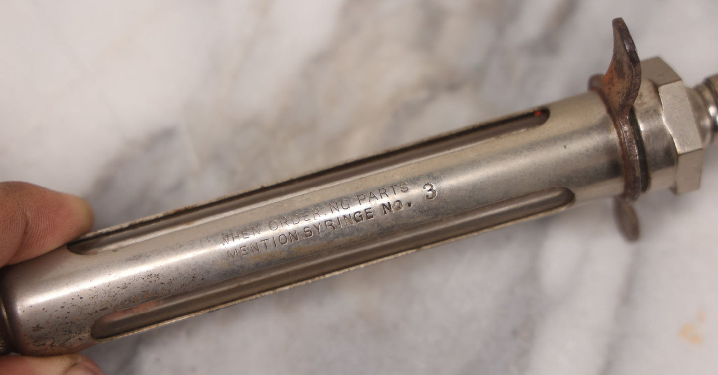 Lot 045 - Antique “Reliable” Brand Syringe No. 3 With Metal Body And Glass Center Tube, With Box Of Vintage B.D. Needles