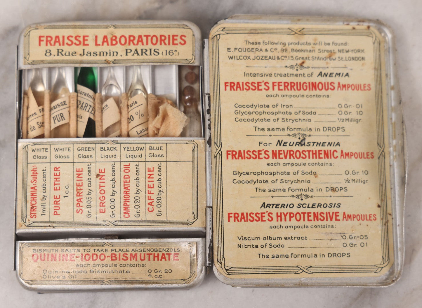 Lot 046 - Antique French Tin “Emergency Medical Pocket” By Fraisse Laboratories, Paris, With Five Glass Ampules, Pill Vial, And Original Paper Inserts