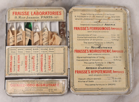 Lot 046 - Antique French Tin “Emergency Medical Pocket” By Fraisse Laboratories, Paris, With Five Glass Ampules, Pill Vial, And Original Paper Inserts