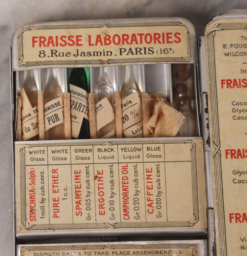Lot 046 - Antique French Tin “Emergency Medical Pocket” By Fraisse Laboratories, Paris, With Five Glass Ampules, Pill Vial, And Original Paper Inserts