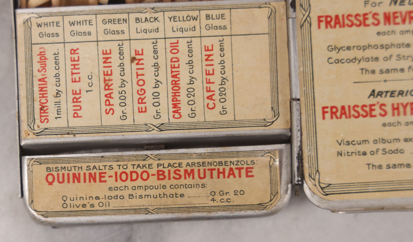 Lot 046 - Antique French Tin “Emergency Medical Pocket” By Fraisse Laboratories, Paris, With Five Glass Ampules, Pill Vial, And Original Paper Inserts