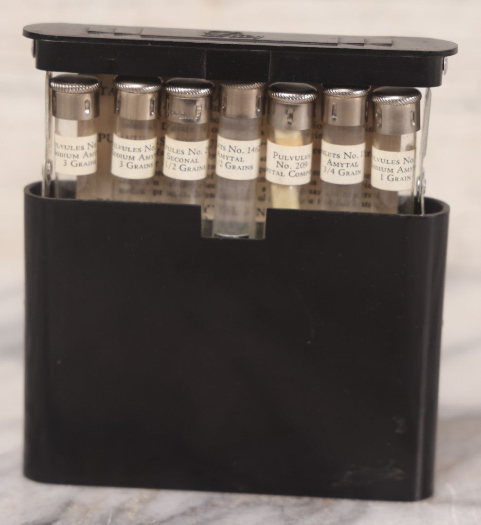 Lot 047 - Vintage Eli Lilly Bakelite Vial Holder With Seven Glass Vials With Paper Labels Including Amytal Compounds, With Paper Insert
