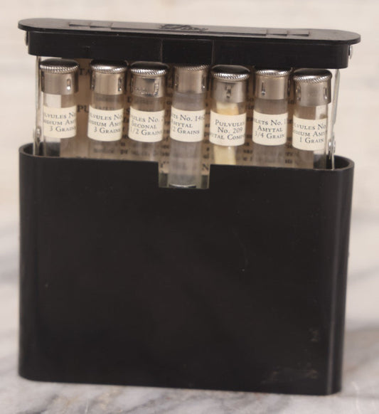 Lot 047 - Vintage Eli Lilly Bakelite Vial Holder With Seven Glass Vials With Paper Labels Including Amytal Compounds, With Paper Insert
