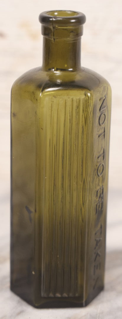 Lot 051 - Antique J. Lumb & Co. Ltd. Green Glass Poison Bottle With Embossed Lettering “Not To Be Taken,” Vertical Poison Ribs, 8 Oz. Size, Castleford, Yorkshire, England, Circa 1880s, 6-5/8" H