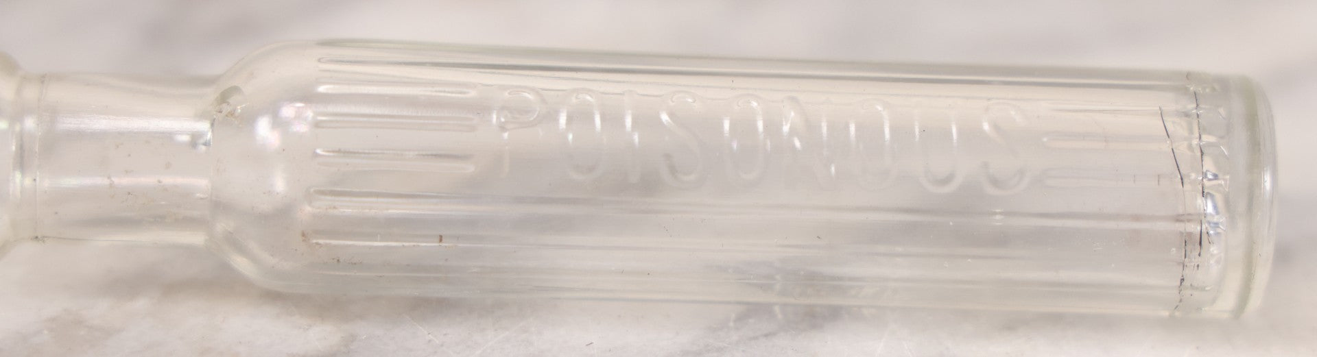 Lot 055 - Antique Narrow Clear Glass Poison Bottle With Embossed Lettering “Poisonous,” Vertical Poison Ribs, 4-1/2" H