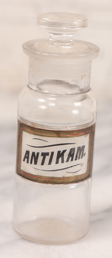 Lot 056 - Antique Whitall Tatum Co. Clear Glass Apothecary Bottle With Stopper And Reverse Painted Label “Antikam.” (Antikamnia), Small Size, 4-3/8" H