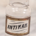 Lot 056 - Antique Whitall Tatum Co. Clear Glass Apothecary Bottle With Stopper And Reverse Painted Label “Antikam.” (Antikamnia), Small Size, 4-3/8" H
