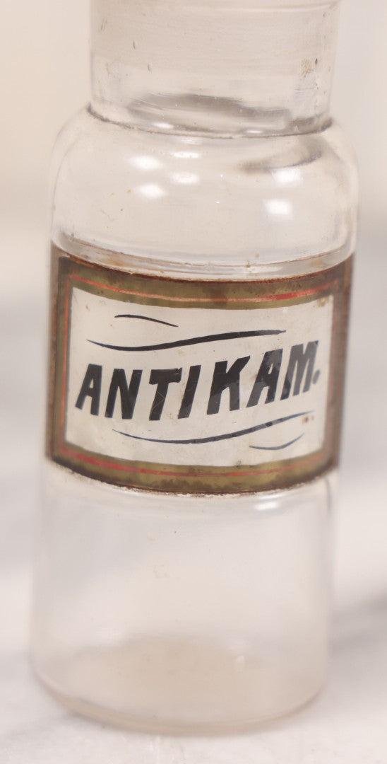 Lot 056 - Antique Whitall Tatum Co. Clear Glass Apothecary Bottle With Stopper And Reverse Painted Label “Antikam.” (Antikamnia), Small Size, 4-3/8" H