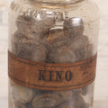 Lot 058 - Antique Apothecary Bottle With Original Paper Label “Kino, London Hospital Throat Lozenges” With Contents, Clear Glass Bottle With Stopper Manufactured By George C. Frye, Portland, Maine, 8" H