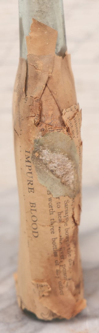 Lot 059 - Antique Ayer's Clear Glass Bottle With Partial Paper Label Wrapper And Embossed Base, 7-1/2" H