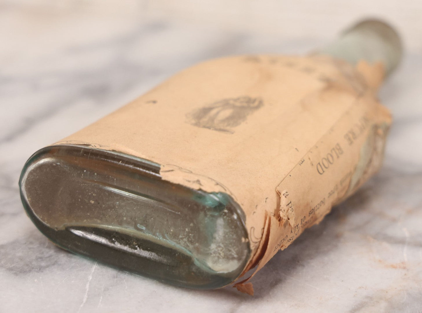 Lot 059 - Antique Ayer's Clear Glass Bottle With Partial Paper Label Wrapper And Embossed Base, 7-1/2" H