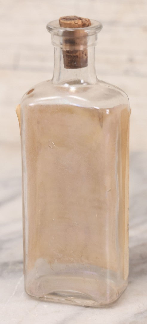 Lot 060 - Antique Clear Glass Bottle With Paper Label “It Beats The Devil” Showing Devil Race Graphics, Arthur N. Roe, Branchville, New Jersey, 5-1/2" H