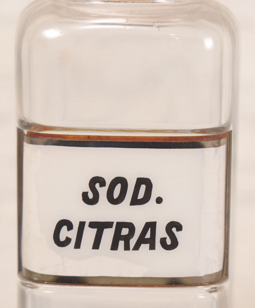 Lot 061 - Antique Whitall Tatum Co. Clear Glass Apothecary Bottle With Stopper And Reverse Painted Label “Sod. Citras”, 7-3/4" H