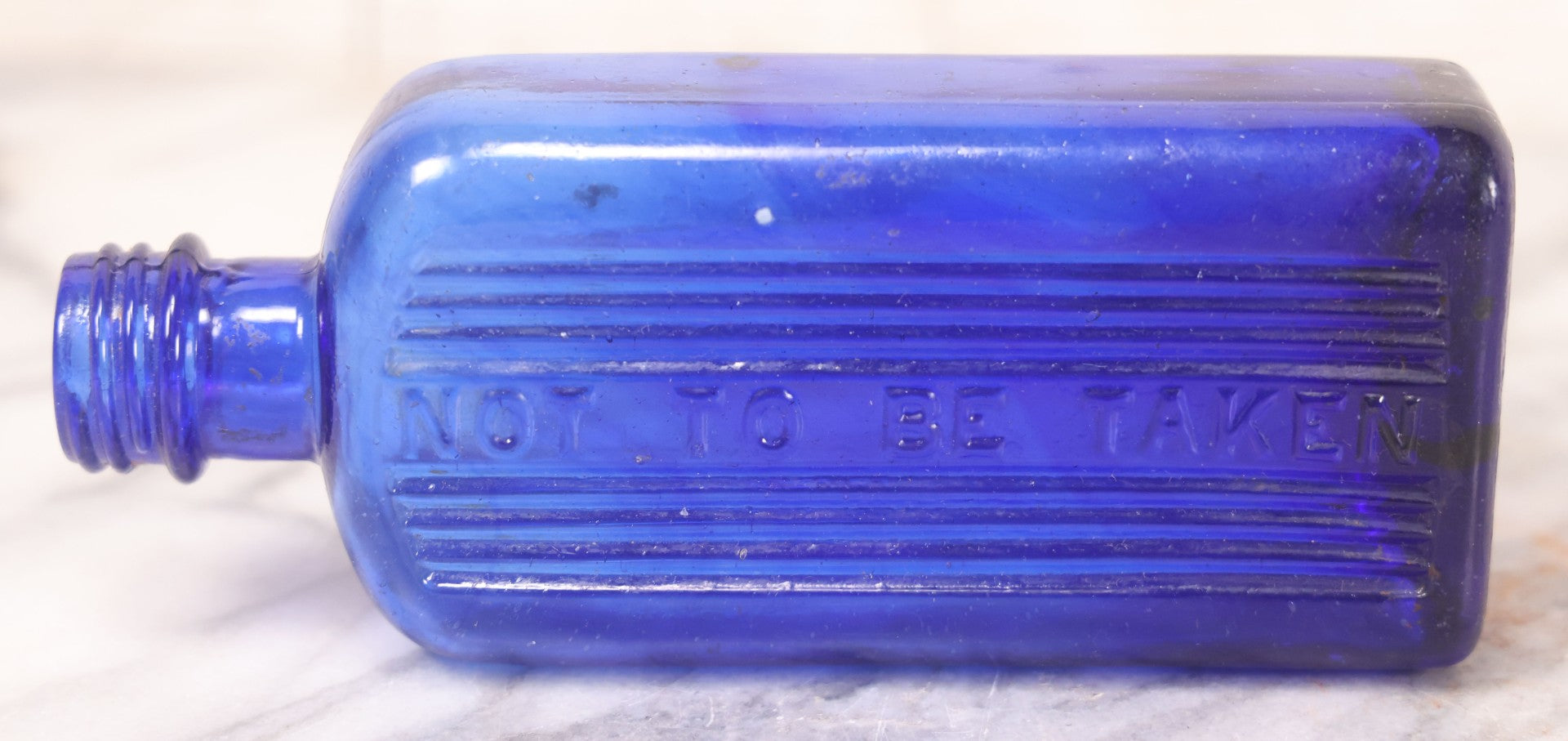 Lot 064 - Grouping Of Three Antique Cobalt Blue Glass Poison Bottles With Embossed Lettering “Not To Be Taken,” Rectangular Form With Vertical Poison Ribs, Three Sizes