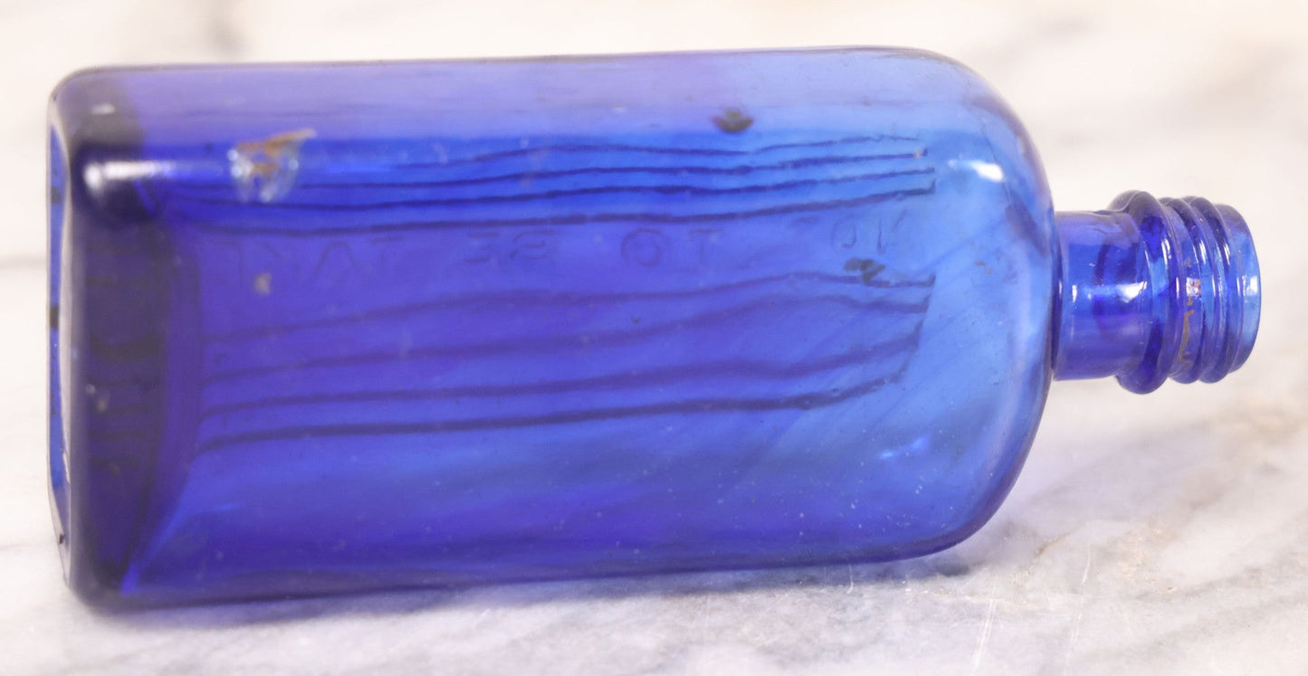 Lot 064 - Grouping Of Three Antique Cobalt Blue Glass Poison Bottles With Embossed Lettering “Not To Be Taken,” Rectangular Form With Vertical Poison Ribs, Three Sizes