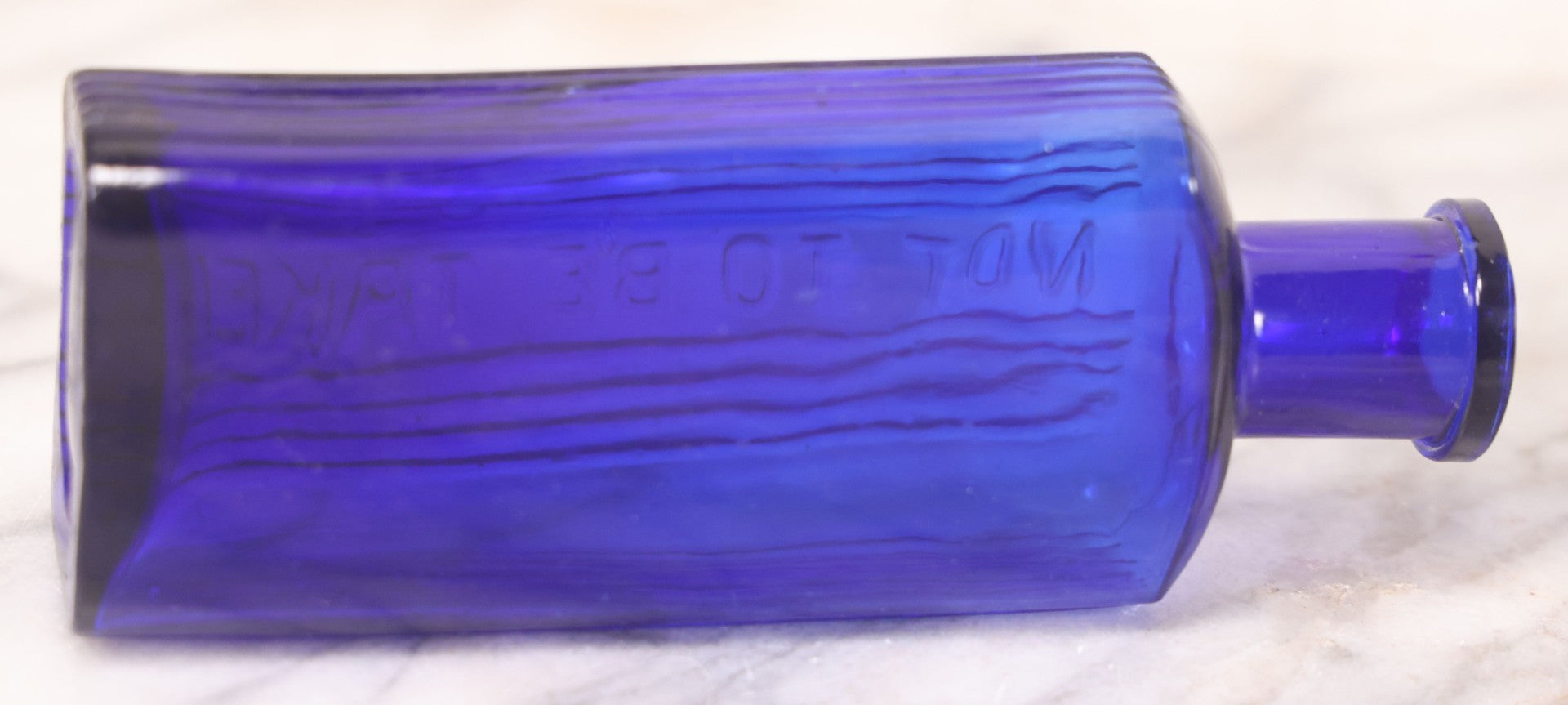 Lot 064 - Grouping Of Three Antique Cobalt Blue Glass Poison Bottles With Embossed Lettering “Not To Be Taken,” Rectangular Form With Vertical Poison Ribs, Three Sizes