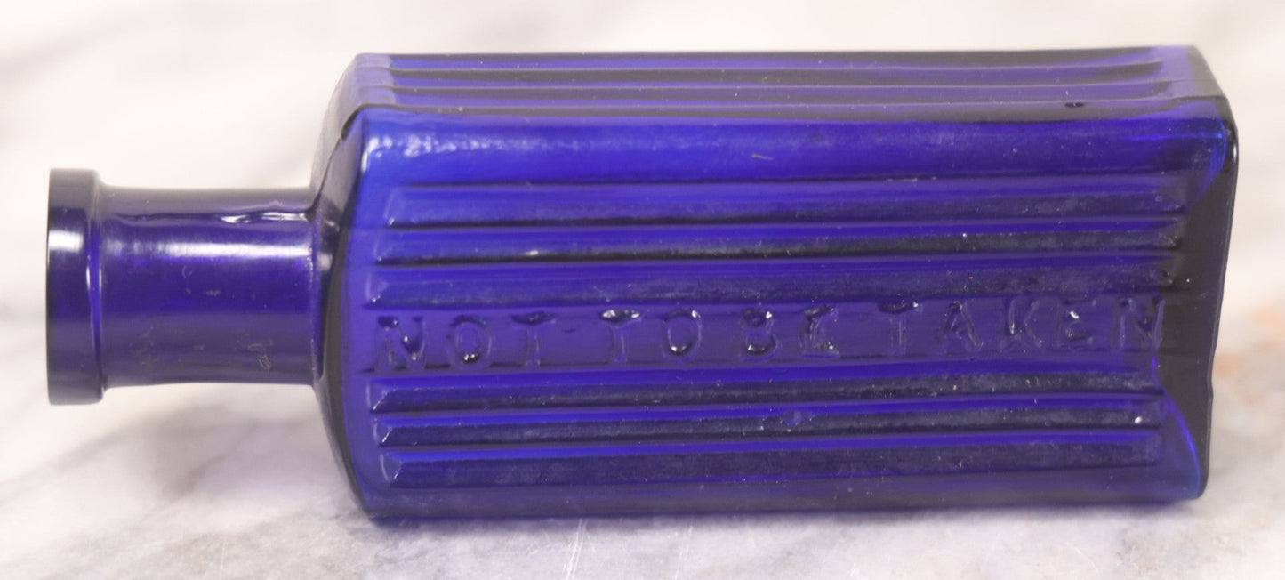 Lot 064 - Grouping Of Three Antique Cobalt Blue Glass Poison Bottles With Embossed Lettering “Not To Be Taken,” Rectangular Form With Vertical Poison Ribs, Three Sizes
