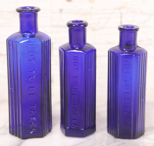 Lot 065 - Grouping Of Three Antique Cobalt Blue Glass Poison Bottles With Embossed Lettering “Not To Be Taken,” Hexagonal Form With Vertical Poison Ribs, Two 2Oz And One 3Oz, 3Oz Marked Y.C. Co.